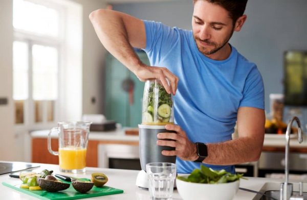 Man making healthy juice drink.